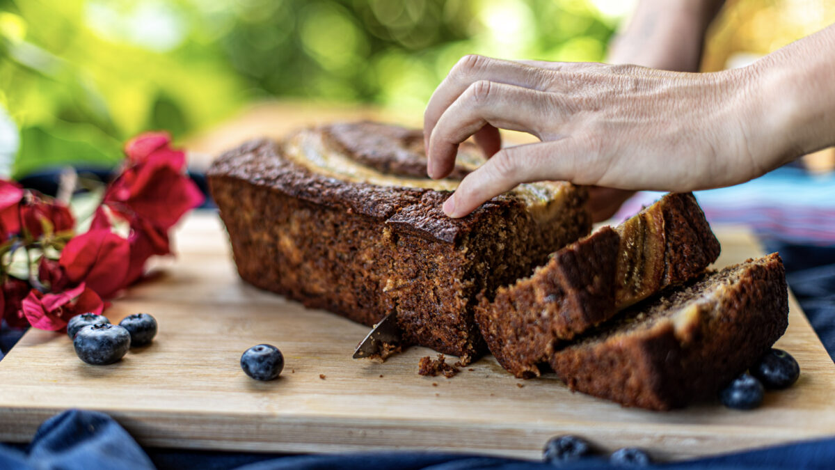 Freshly baked banana bread loaf being sliced at Indigo Vibe Cafe in Kilifi