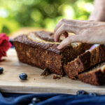 Freshly baked banana bread loaf being sliced at Indigo Vibe Cafe in Kilifi