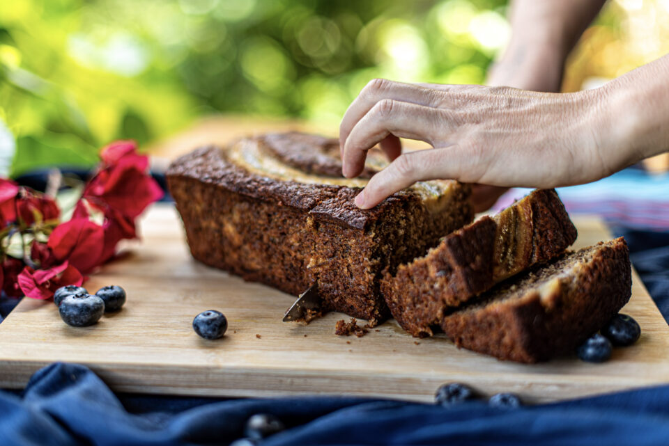 Freshly baked banana bread loaf being sliced at Indigo Vibe Cafe in Kilifi