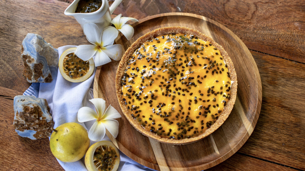 Passion fruit cheesecake decorated with white flowers, made at Indigo Vibe Cafe in Kilifi
