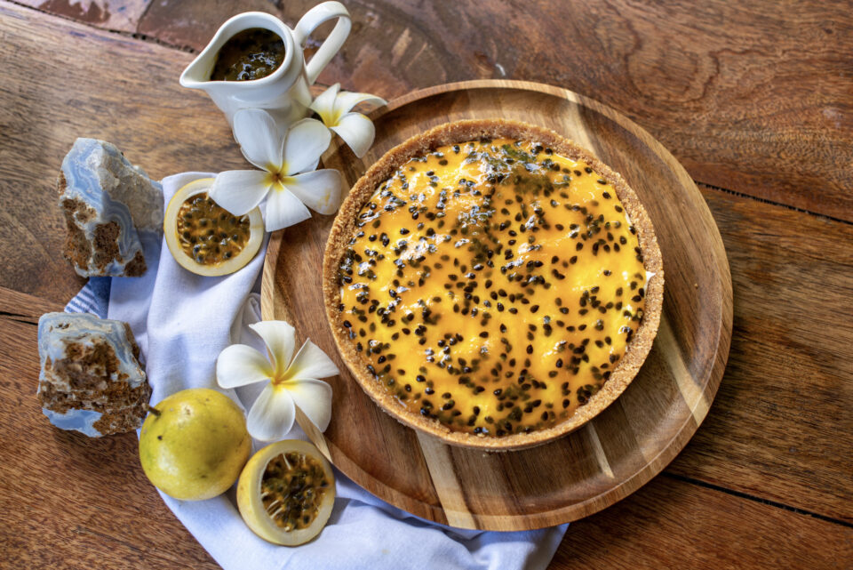Passion fruit cheesecake decorated with white flowers, made at Indigo Vibe Cafe in Kilifi