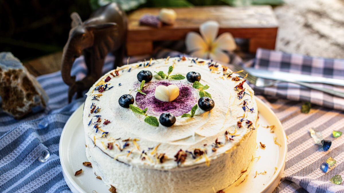 Carrot cake decorated with berries and flowers, made at Indigo Vibe Cafe in Kilifi