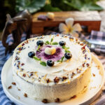 Carrot cake decorated with berries and flowers, made at Indigo Vibe Cafe in Kilifi