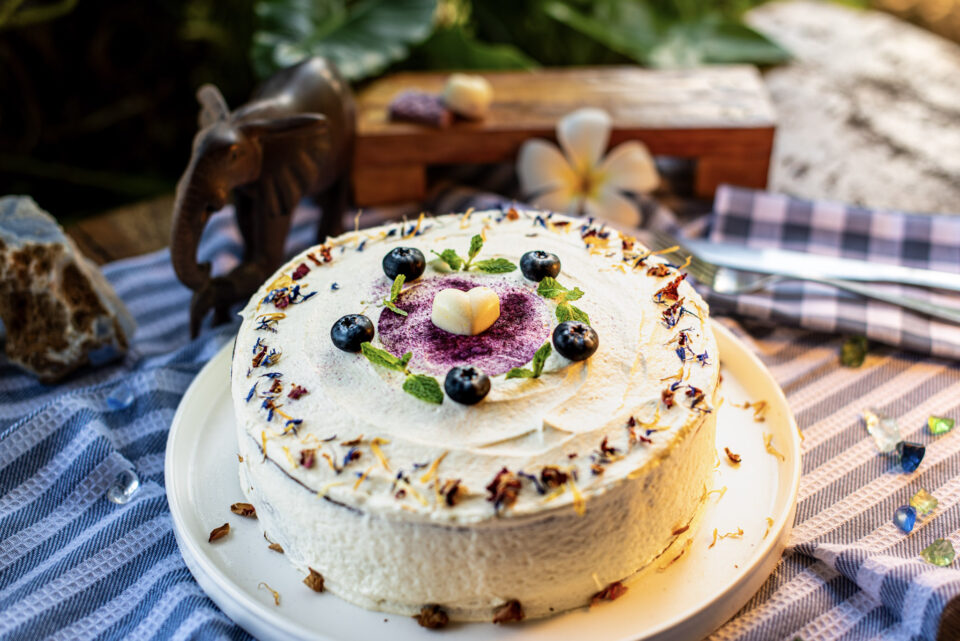 Carrot cake decorated with berries and flowers, made at Indigo Vibe Cafe in Kilifi